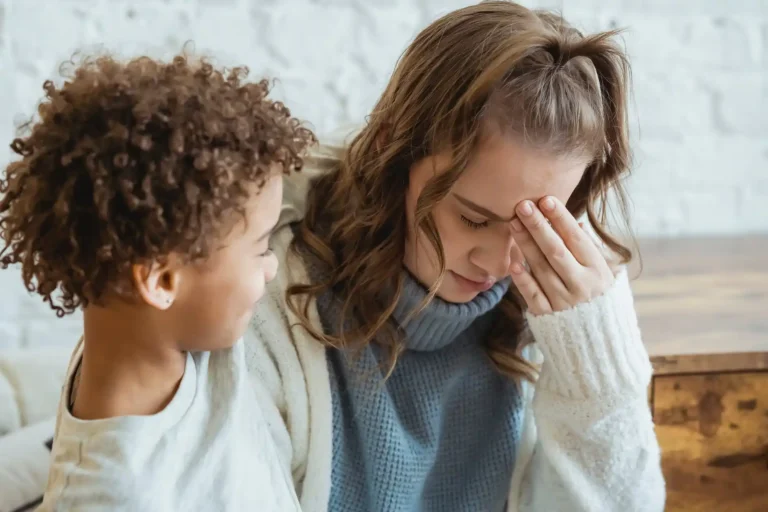 What is motherhood really like? Woman being comforted by son