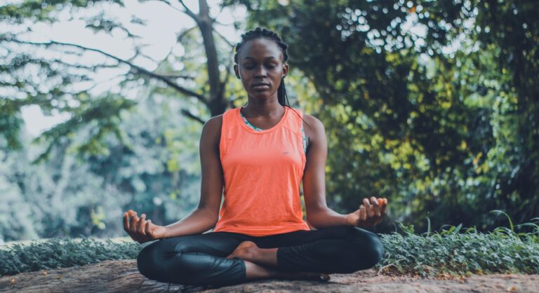 woman meditating in the outdoors. Books for World Meditation Day
