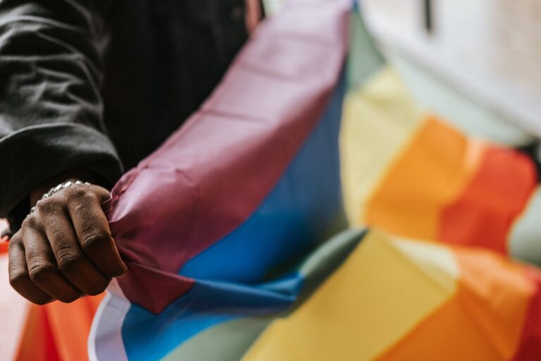 crop unrecognizable black gay. demonstrating lgbt flag. Pride month books