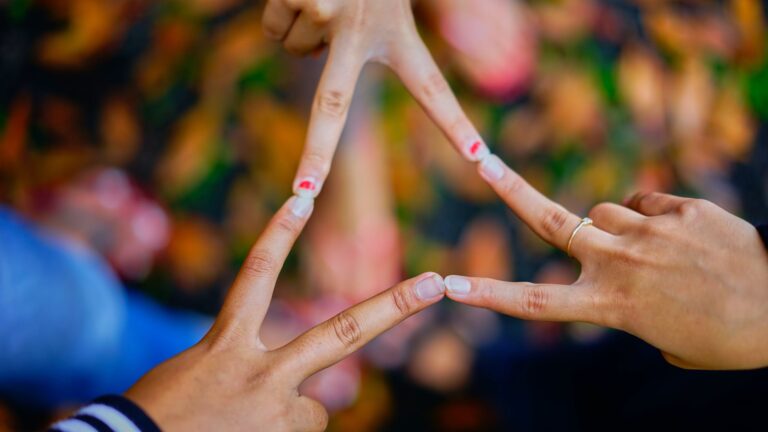 photography of people connecting their fingers, as Dr Daniel J. Siegel explains what interconnected and intraconnection means