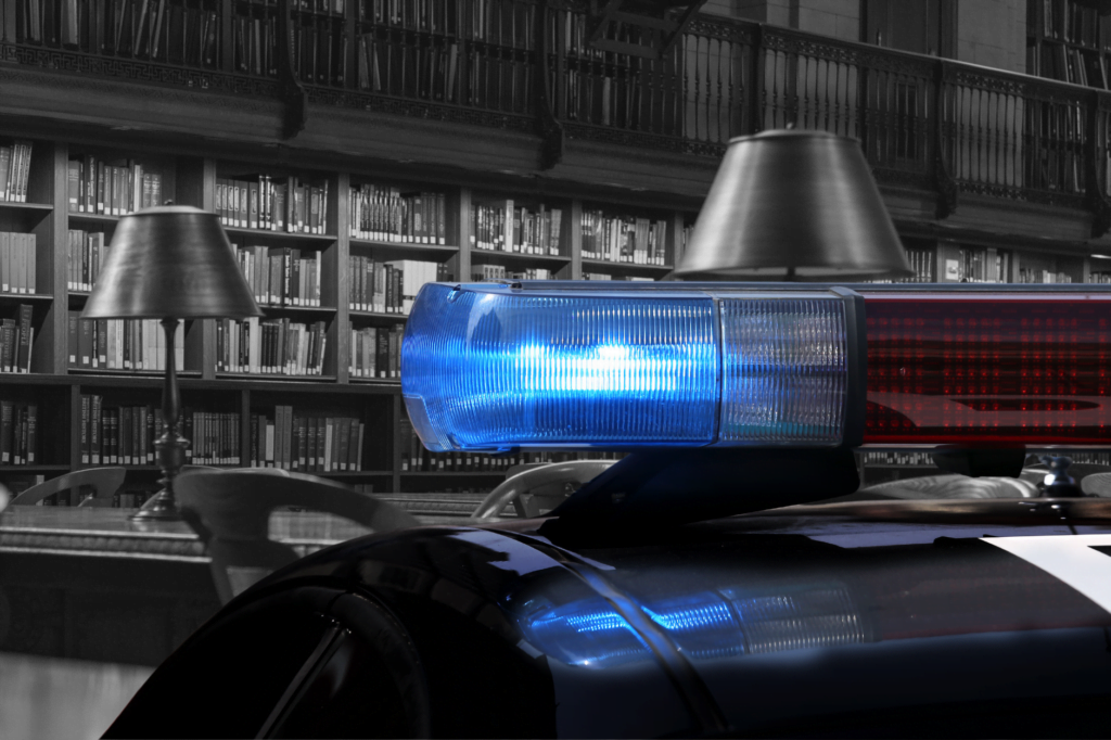 Wave of bomb threats target Minnesota libraries. Police car sirens in front of black and white image of library book shelves and tables.