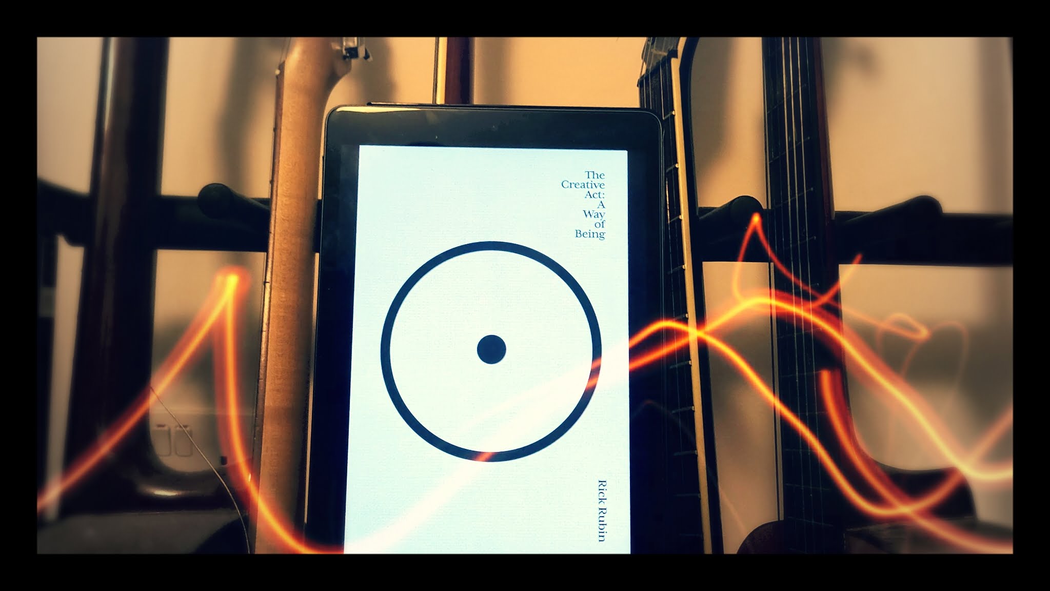 Rick Rubin's book on tablet with guitars behind