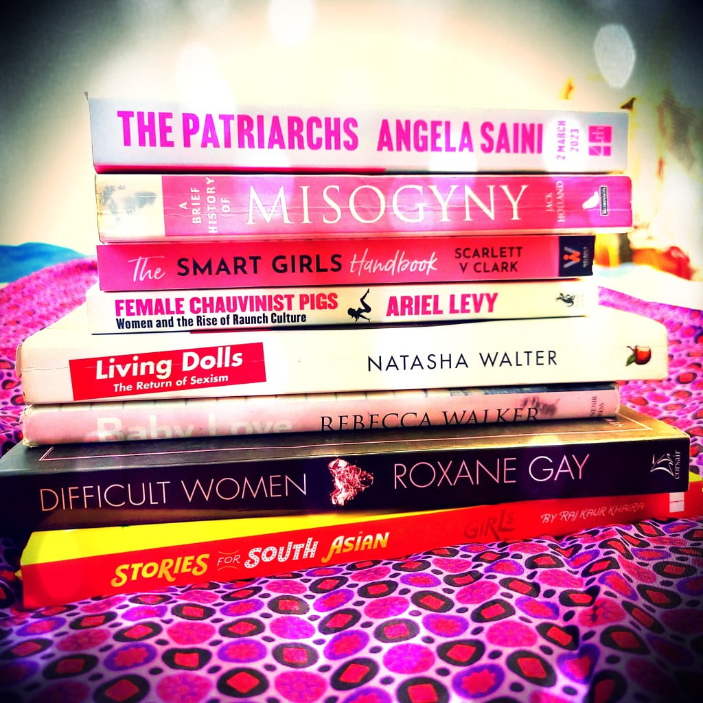 Stack of feminist books with pink covers as Barbie movie comes out