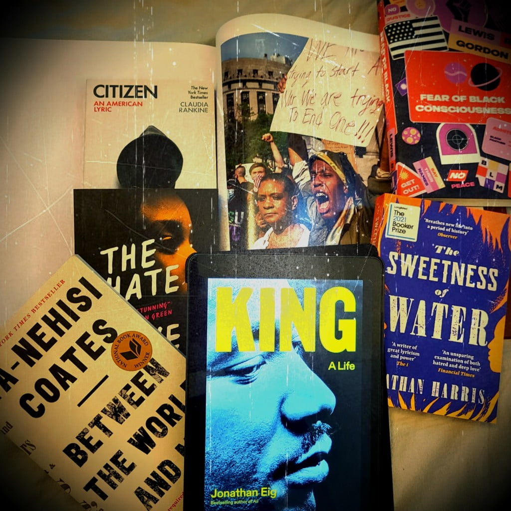 Martin Luther King Jr book by Jonathan Eig surrounded by books Between the World and Me by Ta-Nehisi Coates, The Hate U Give by Angie Thomas, Citizen by Claudia Rankine, Fear of Black Consciousness by Professor Lewis R. Gordon, The Sweetness of Water by Nathan Harris and photograph of Black Lives Matter movement by Mitch Epstein.