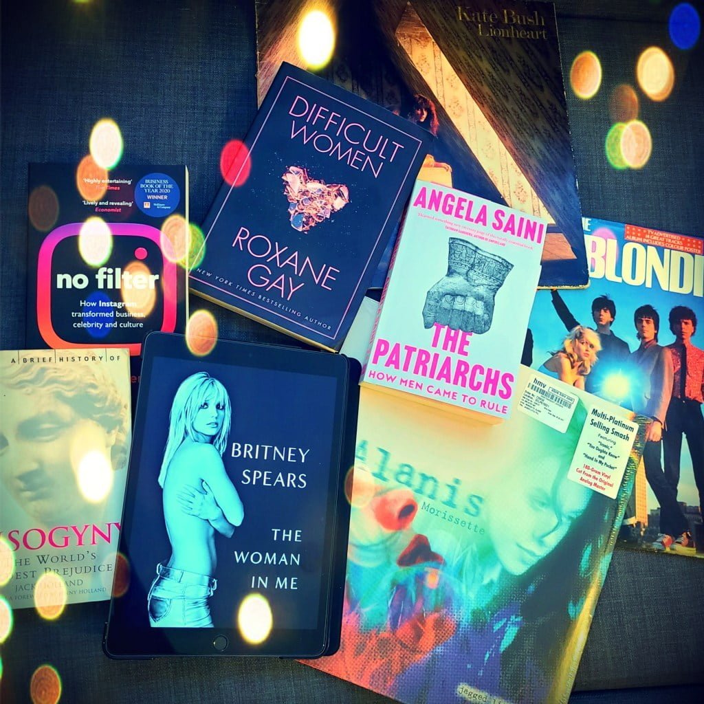 Britney Spears book in front of books No Filter by Sarah Frier, Misogyny by Jack Holland, Difficult Women by Roxane Gay, The Patriarchs by Angela Saini, and vinyl records Blondie, Alanis Morissette and Kate Bush