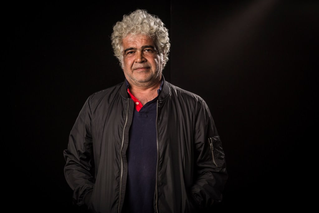 Khaled Khalifa seen in black jacket and blue shirt against a black background as he leaves a legacy of books following his death.