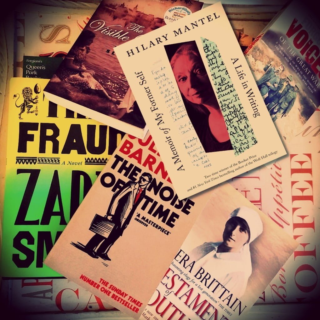 A Memoir of My Former Self by Hilary Mantel in front of historical fiction books on table including The Fraud by Zadie Smith, The Noise of Time by Julian Barnes, The Visible Qorld by Mark Slouka, The Good Earth by Pearl S. Buck, and nonfiction works Testament of Youth by Vera Brittain, and Forgotten Voices by Max Arthur