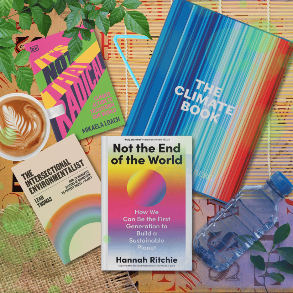 "Not the End of the World" book by Hannah Ritchie on coffee table next to books: "It's Not That Radical" by Mikaela Loach, "The Intersectional Feminist" by Leah Thomas, and "The Climate Book" by Greta Thunberg. Books surrounded by plastic bottle, leaves, bamboo blinds, burlap sack, coffee with milk and plastic straw.