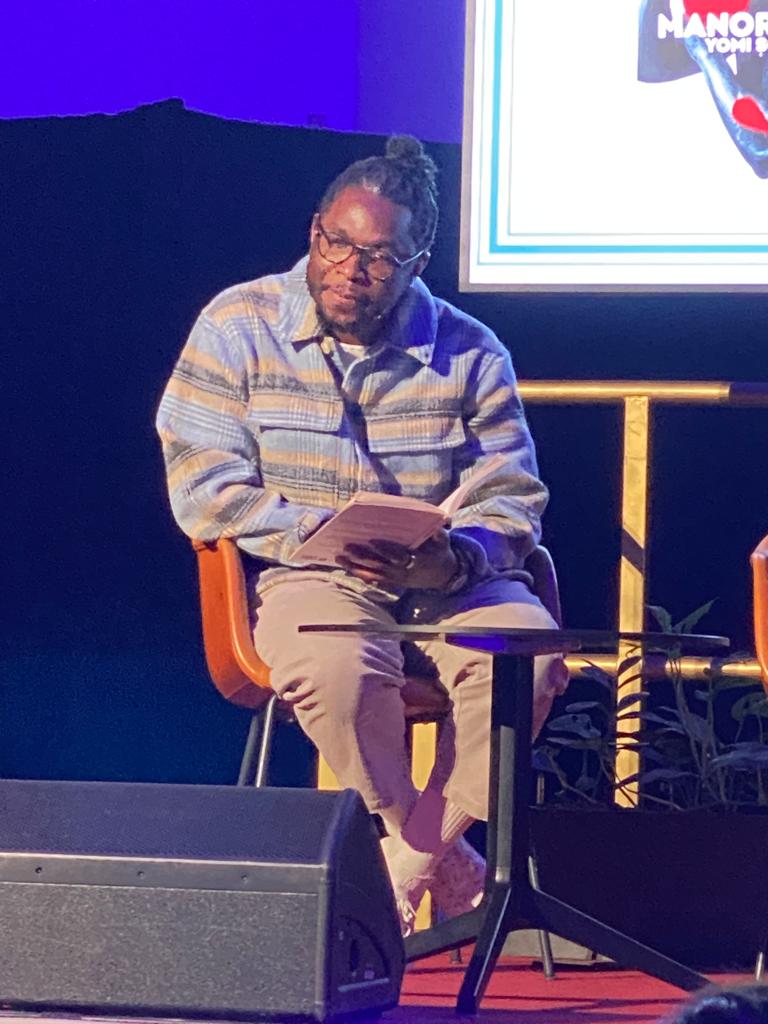 Poet Yomi Sode speaks about book with book in lap
