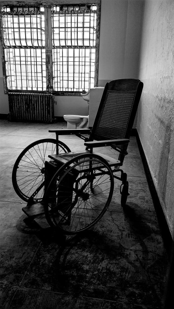 San Francisco literary tour. Black and white image of old wheelchair in Alcatraz prison