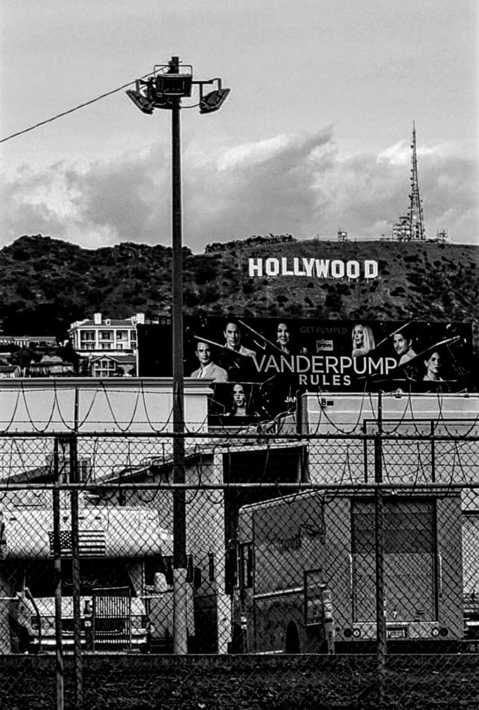 Black and white image of Hollywood sign on hills, pictured from Hollywood Boulevard.