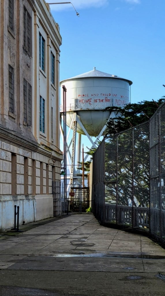 Alcatraz water tower with the words "Peace and freedom, home of the free Indians"