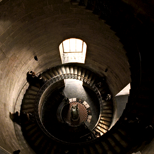 Students walk down spiral staircase in Harry Potter