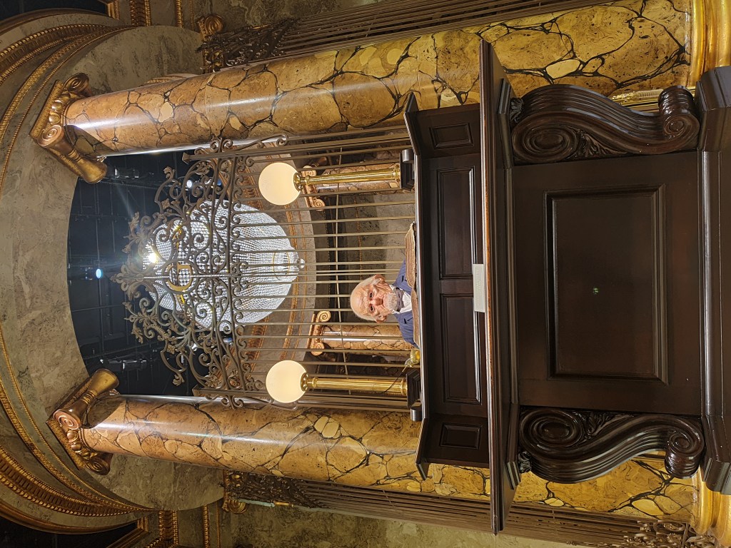Goblin banker sits behind a wooden platform at Gringotts Bank at Warner Bros Studios in the UK.