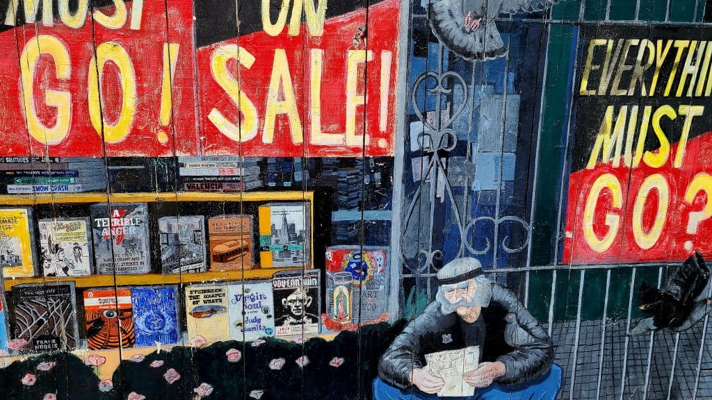 San Francisco literary tour - Clarion Alley Mural Project in the Mission District of San Francisco. The image depicts a vibrant and colorful mural that seems to be celebrating San Francisco's rich literary heritage. It features a faux bookstore window displaying an array of books with titles clearly referencing the city's historical and cultural narratives. The background includes bold red lettering stating "ON SALE!" and "EVERYTHING MUST GO?", adding a dynamic and somewhat satirical tone to the scene. On the right side, an older man is portrayed reading a book, engrossed in its content, emphasizing the timeless appeal of literature. The overall artwork combines elements of urban life with a deep appreciation for books and reading, reflective of the city's historical significance in literary movements.