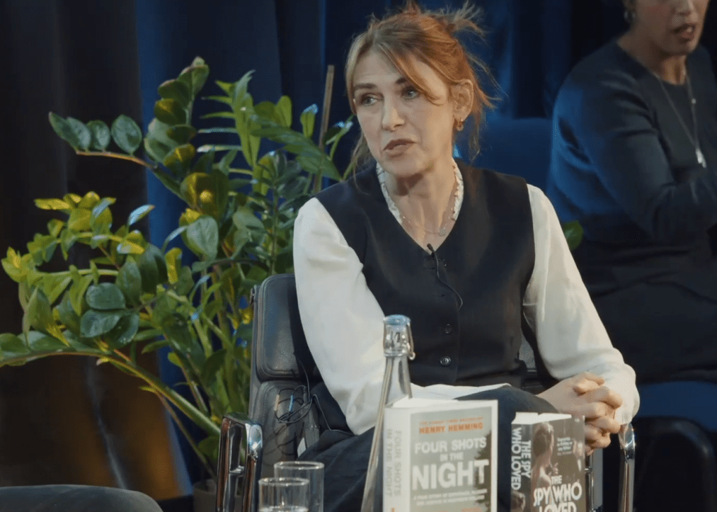 Clare Mulley in a discussion at HistFest 2024, with books displayed on the table in front of her.