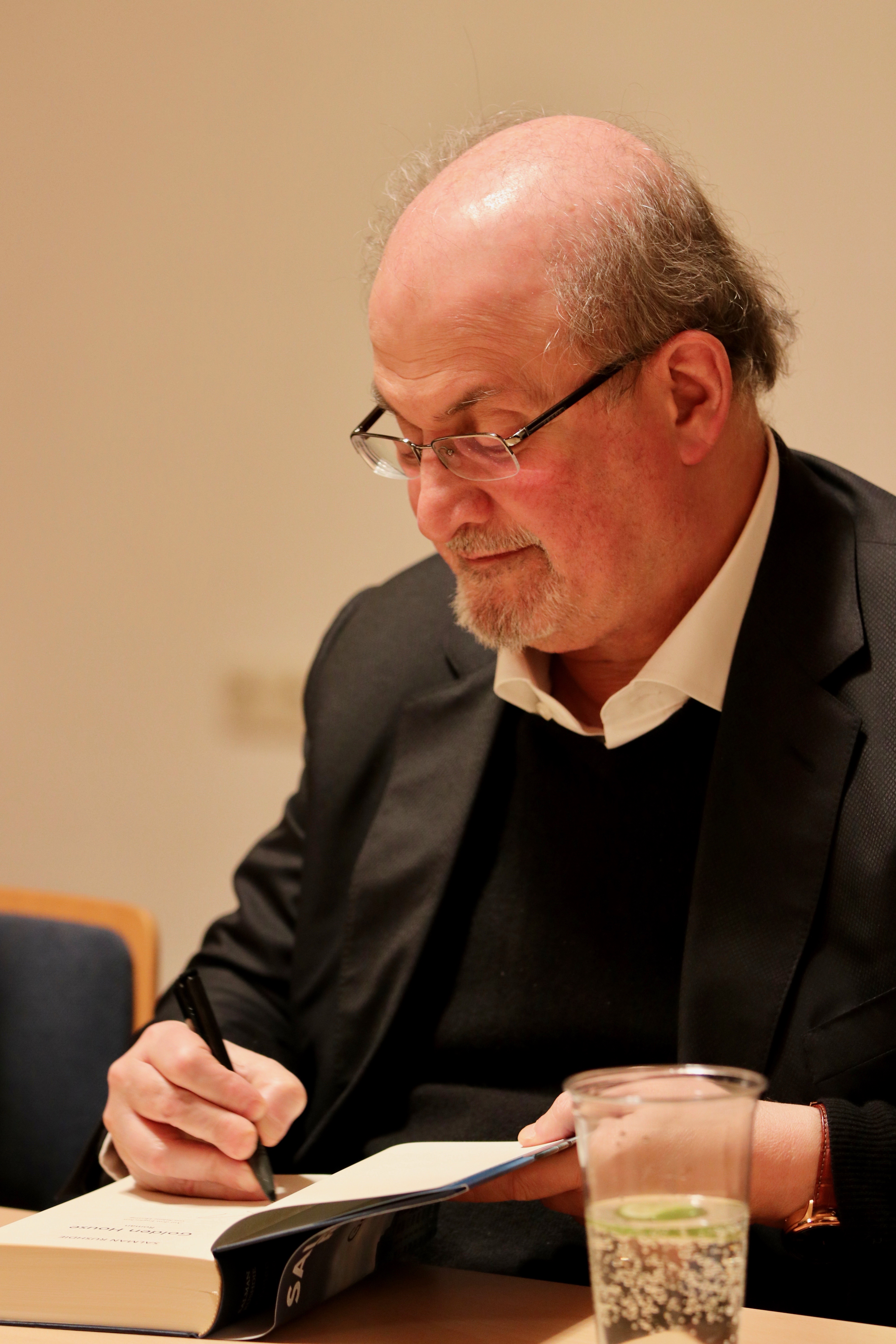 Salman Rushdie signs books at the Munich Literature Festival.